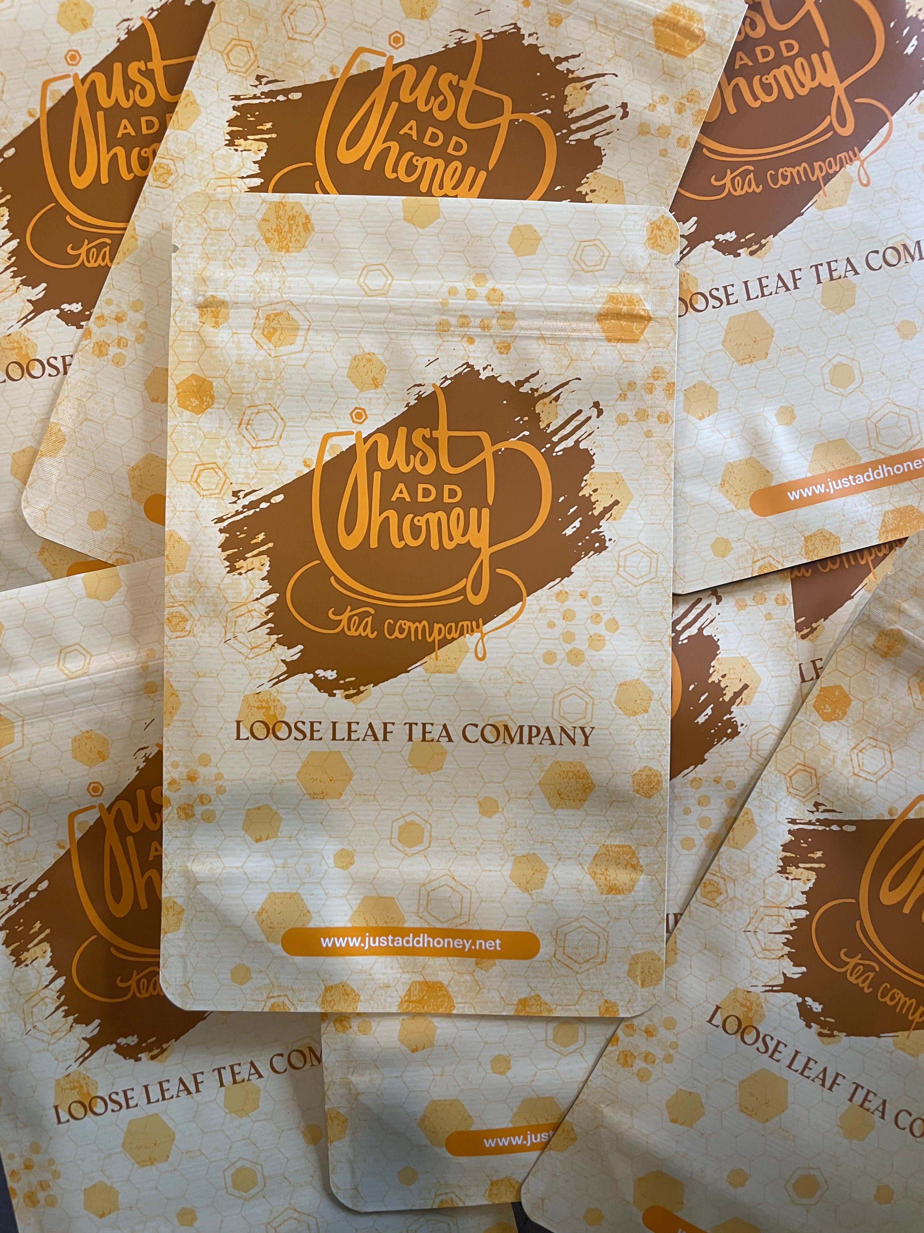 A tea and honey gift set - The set includes a box, tea bags, and honey, packaged in loose leaf tea bags or stainless steel tea tins