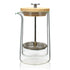 Clear glass coffee press with wooden lid on a white background