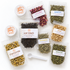 DIY tea kit of two loose leaf teas, five various herbs, teaspoon, and storage containers